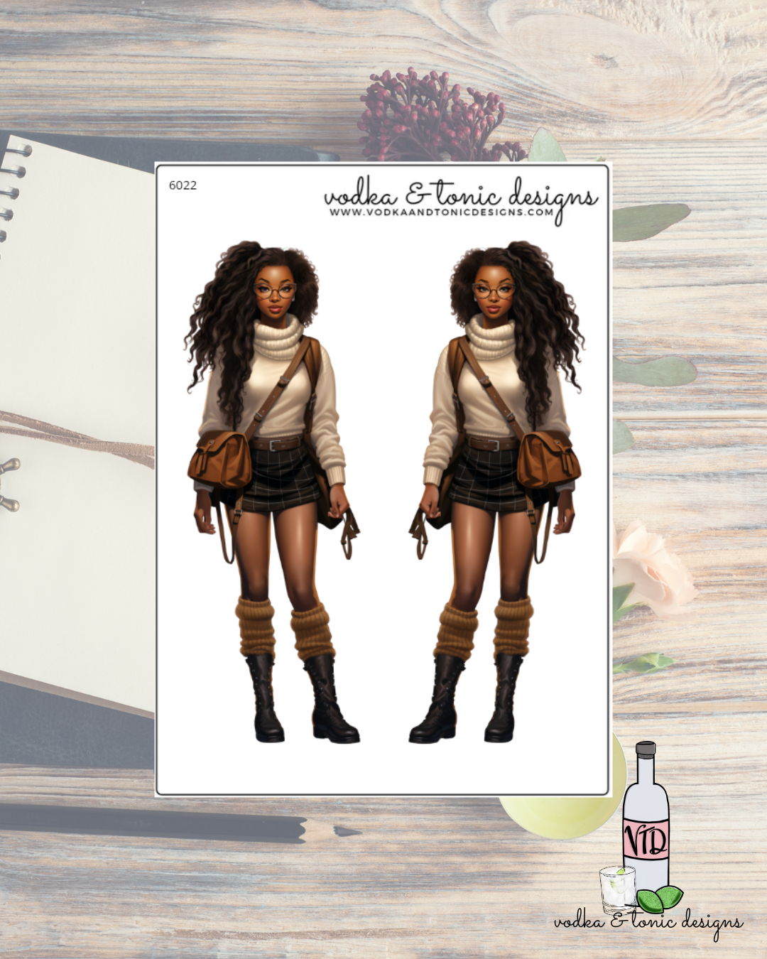 Illustration of a woman in a costume with 'vodka & tonic designs' branding on a wooden surface.